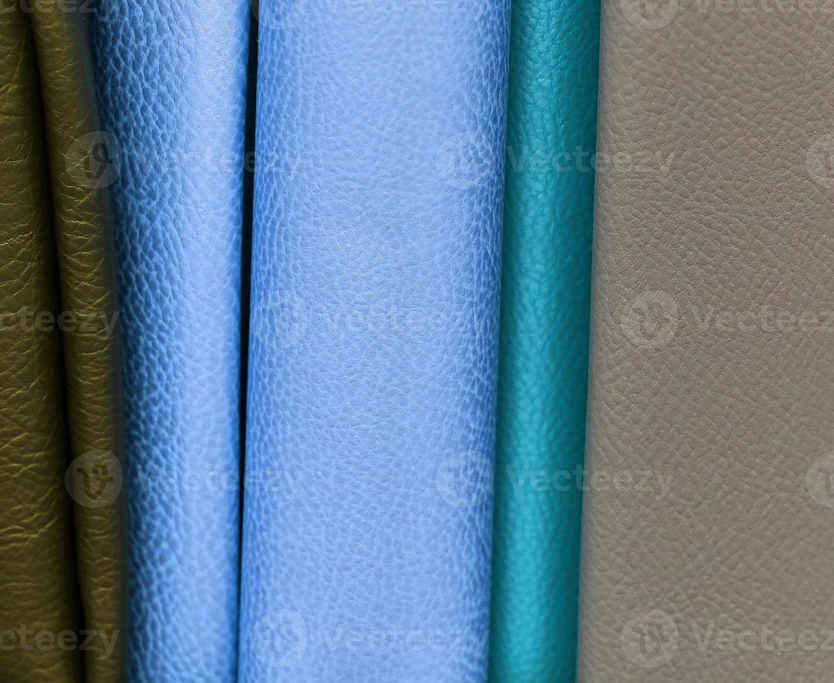 Detailed close up view on samples of cloth and fabrics in different colors found at a fabrics market photo