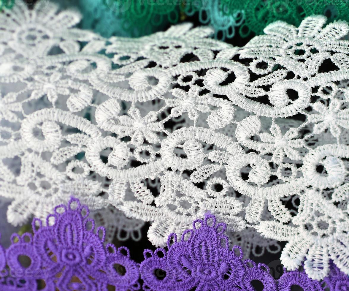 Detailed close up view on samples of cloth and fabrics in different colors found at a fabrics market photo
