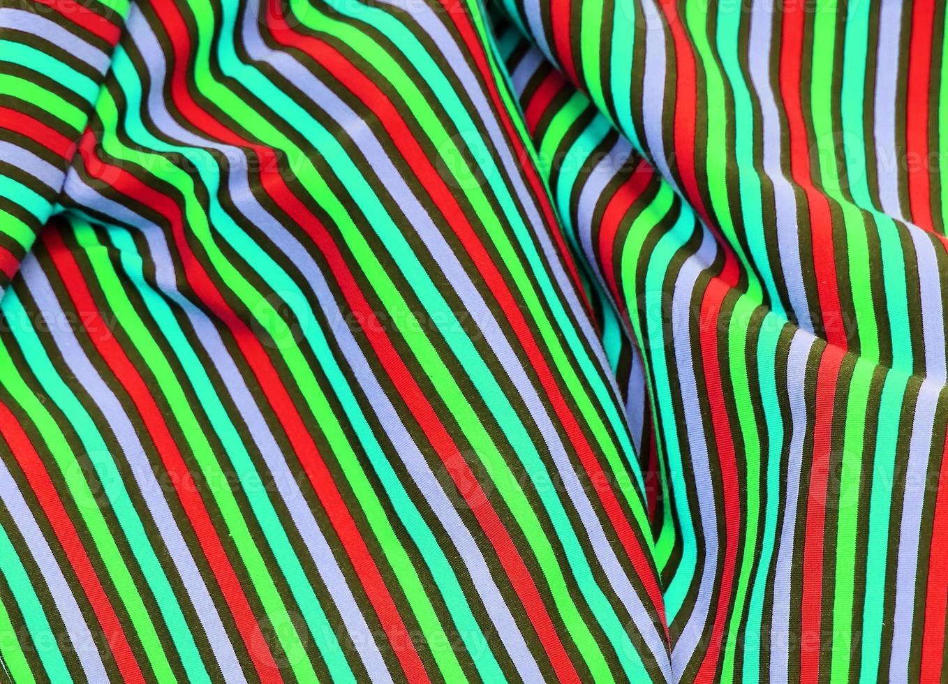 Detailed close up view on samples of cloth and fabrics in different colors found at a fabrics market photo