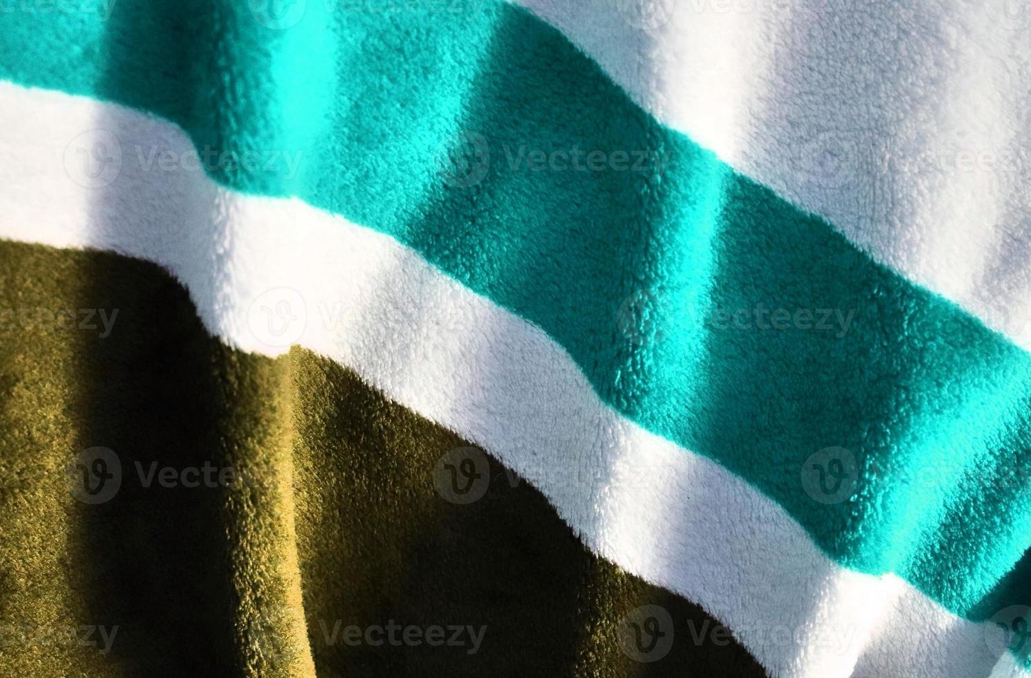 Detailed close up view on samples of cloth and fabrics in different colors found at a fabrics market photo