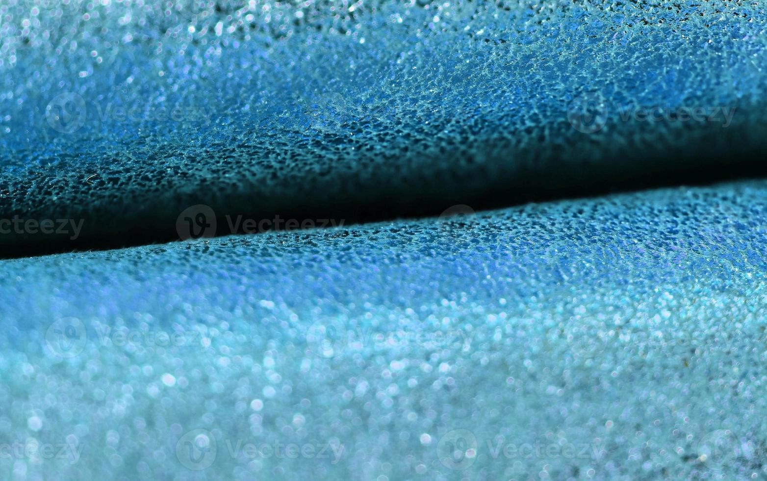 Detailed close up view on samples of cloth and fabrics in different colors found at a fabrics market photo