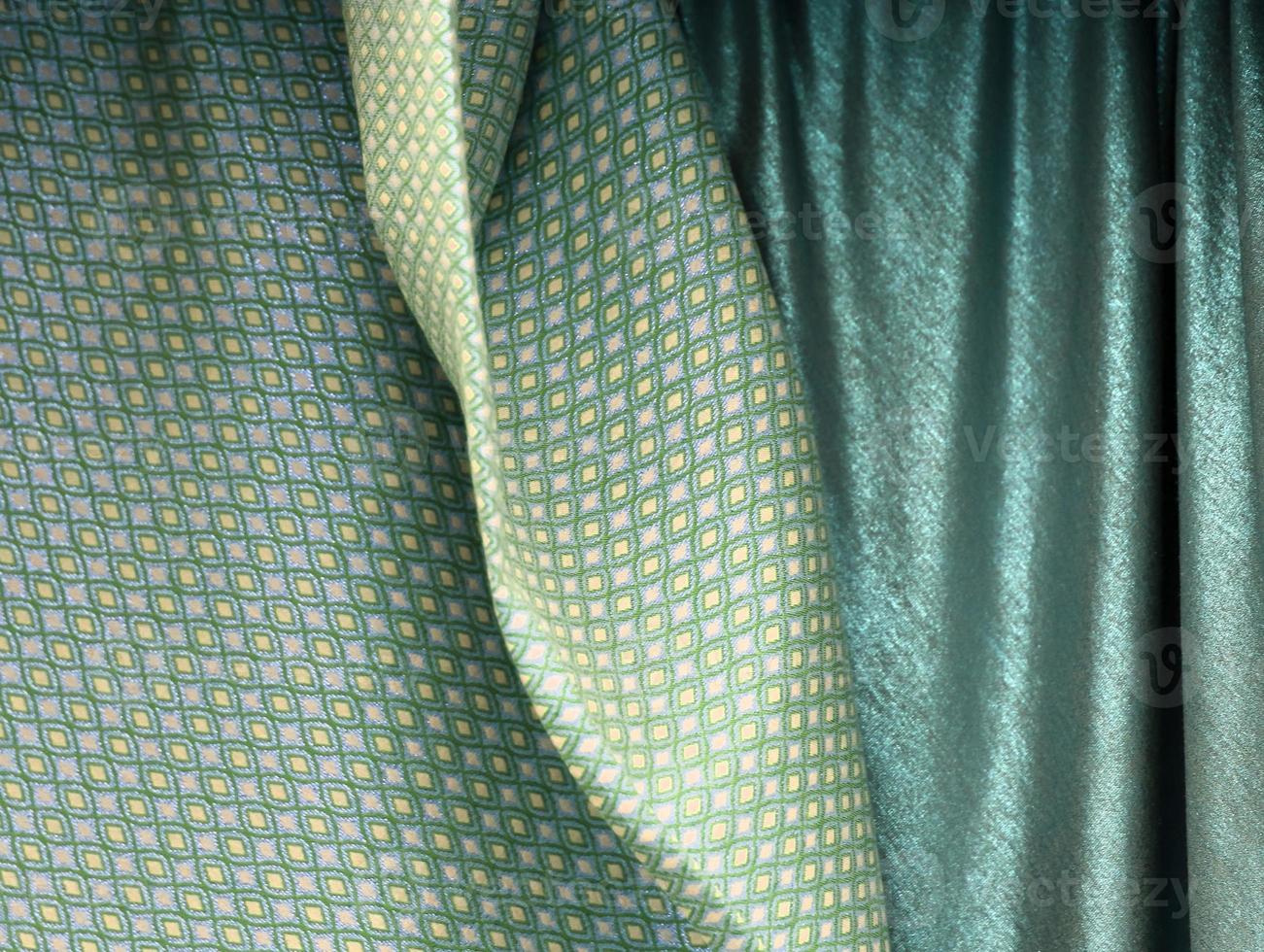 Detailed close up view on samples of cloth and fabrics in different colors found at a fabrics market photo
