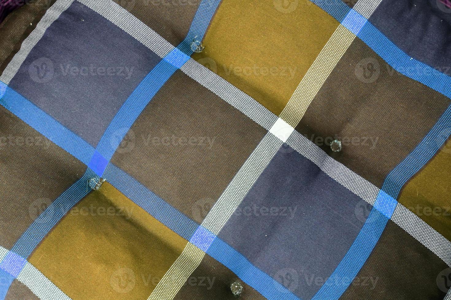Detailed close up view on samples of cloth and fabrics in different colors found at a fabrics market photo