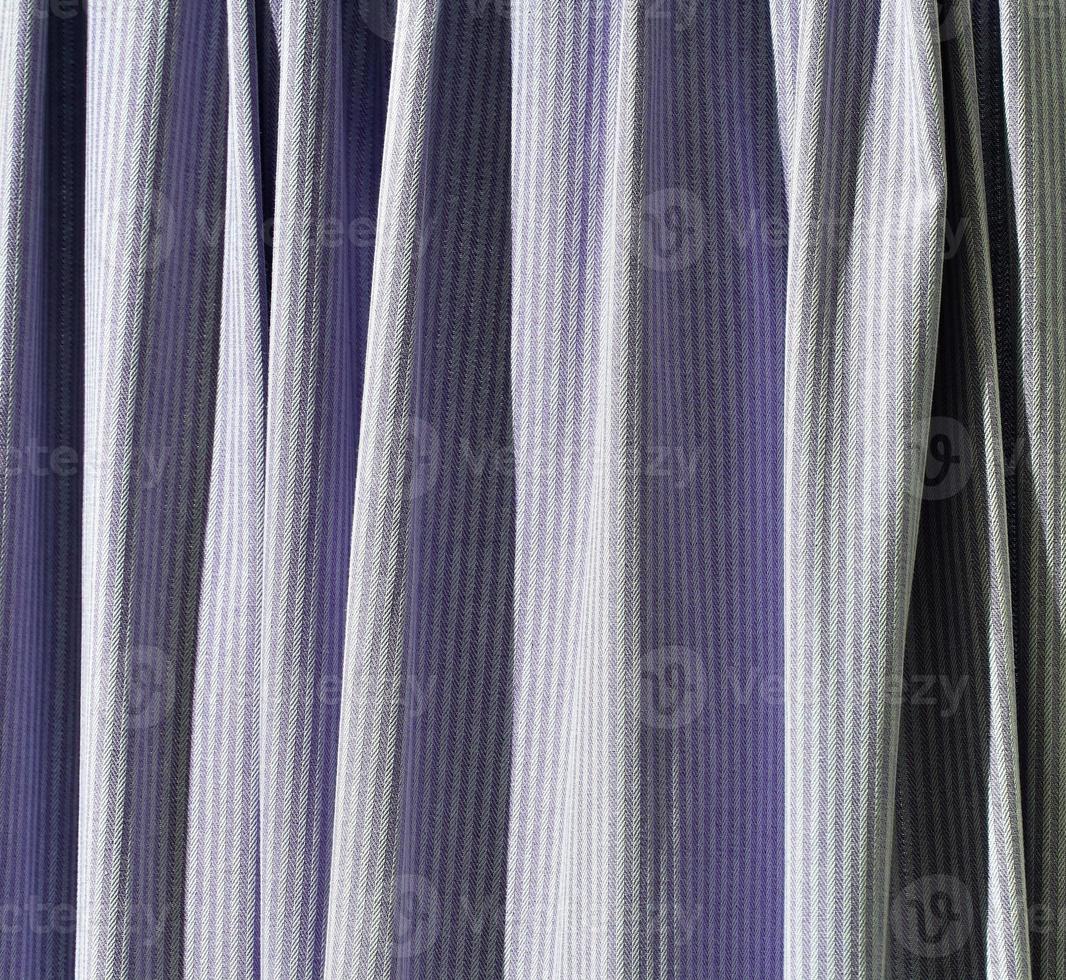 Detailed close up view on samples of cloth and fabrics in different colors found at a fabrics market photo
