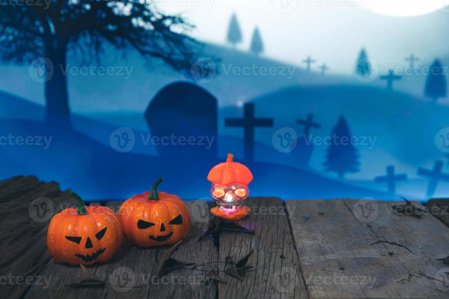 Spooky cemetery with glow halloween pumpkin photo