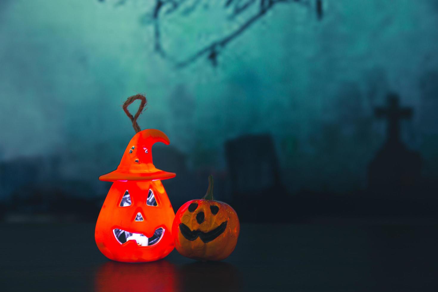 Spooky cemetery with glow halloween pumpkin photo