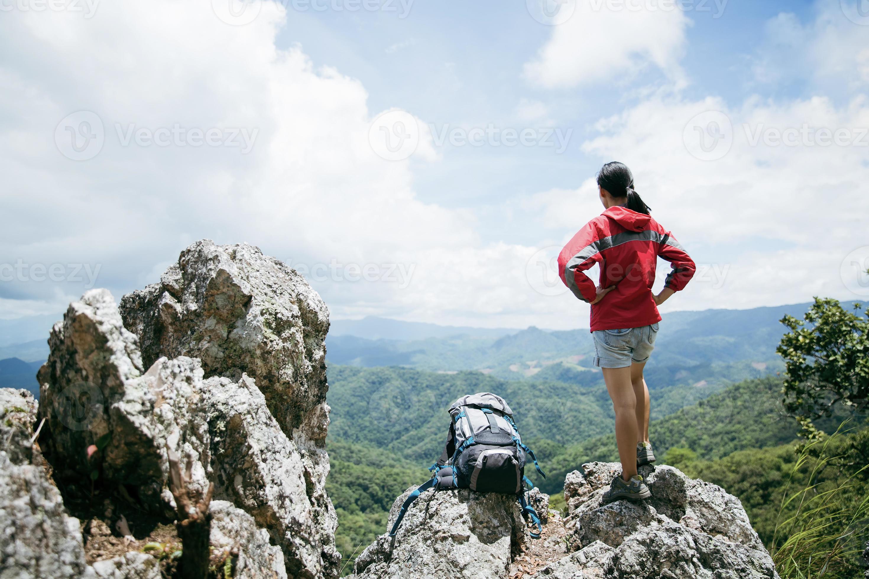 Young person hiking female standing on top rock, Backpack woman looking at  beautiful mountain valley at sunlight in summer, Landscape with sport girl,  high hills, forest, sky. Travel and tourism. 10266232 Stock