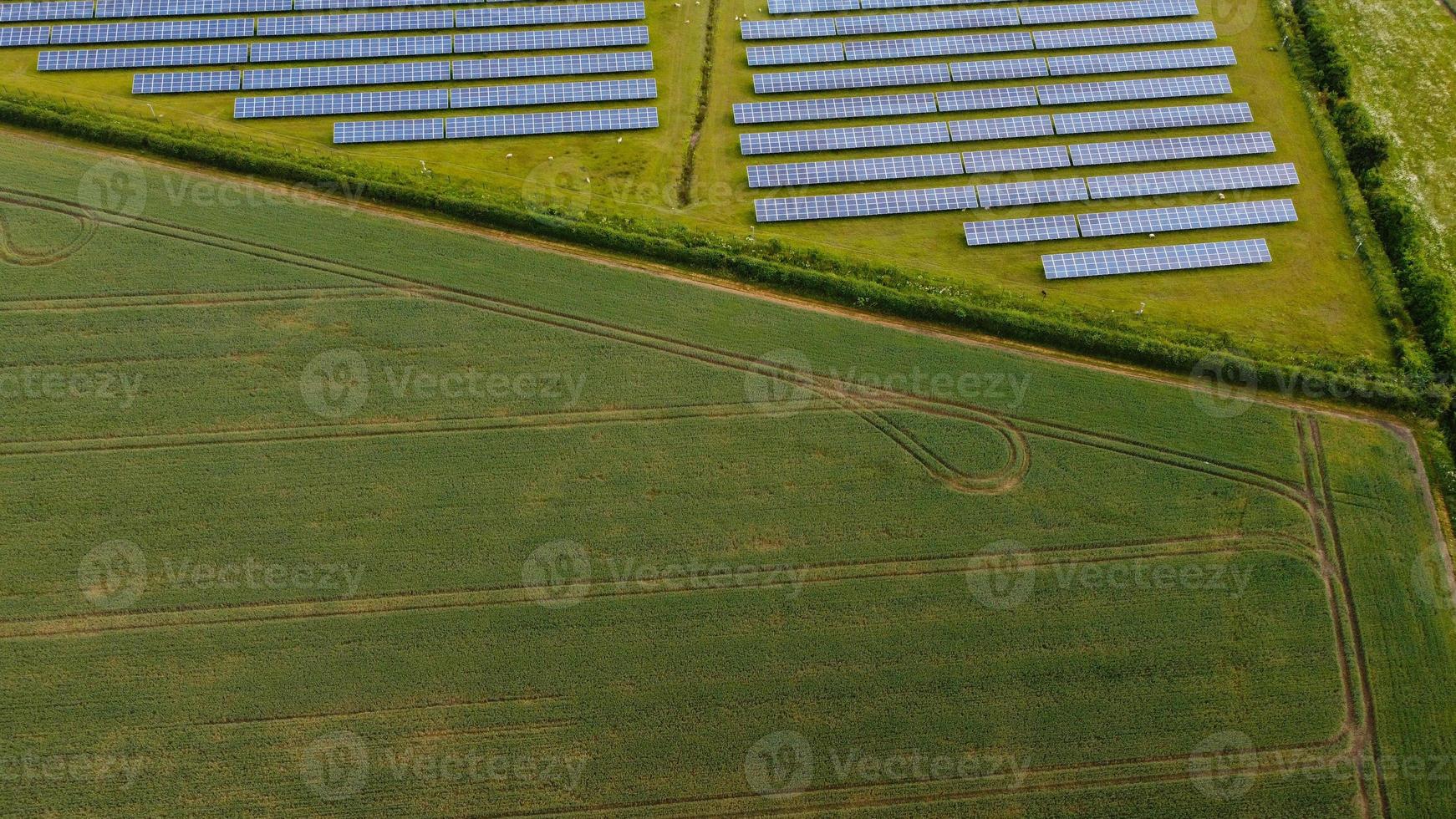 Aerial footage High Angle view of Green Energy natural Generators Sources of Wind turbines and solar panels Farms at England UK photo