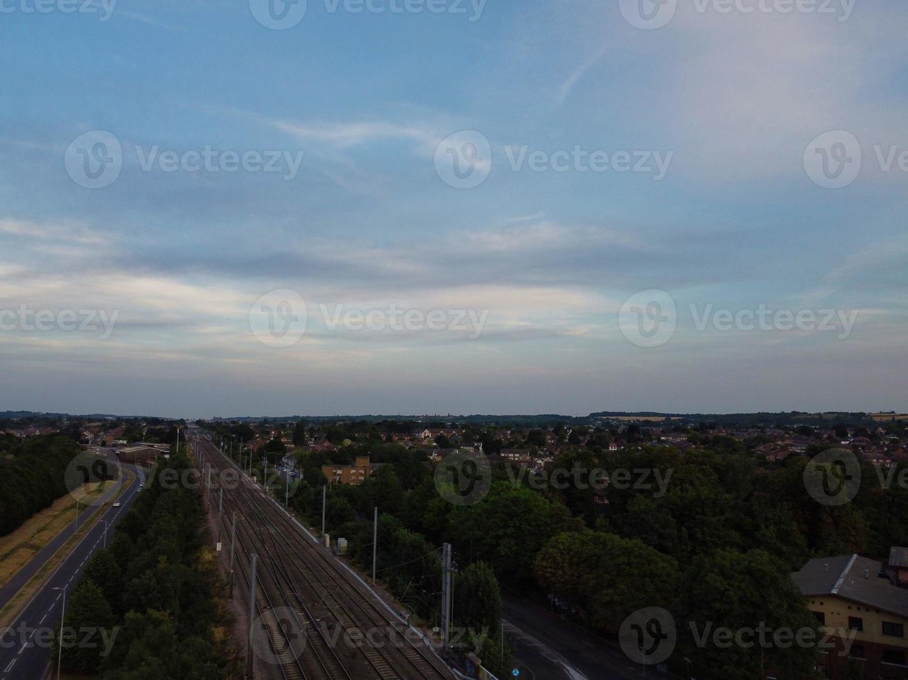 Aerial footage high angle view of Luton Town of England and Railways Station and Train on Tracks at Sunset photo