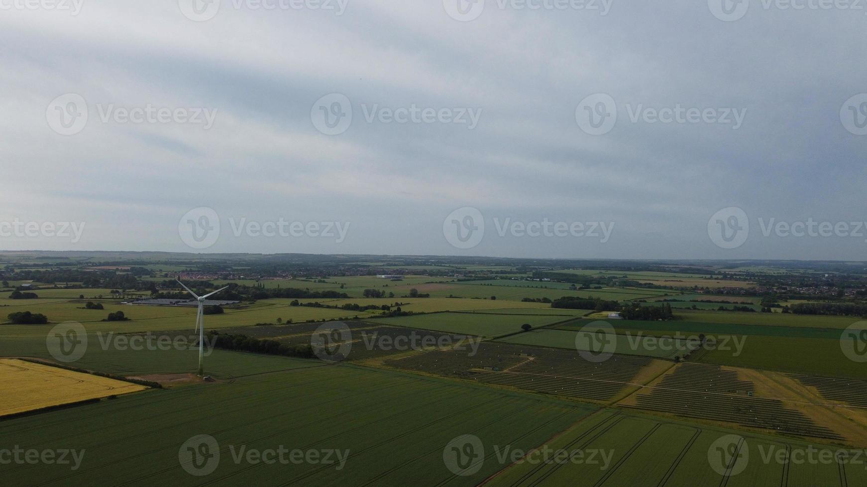 Aerial footage High Angle view of Green Energy natural Generators Sources of Wind turbines and solar panels Farms at England UK photo