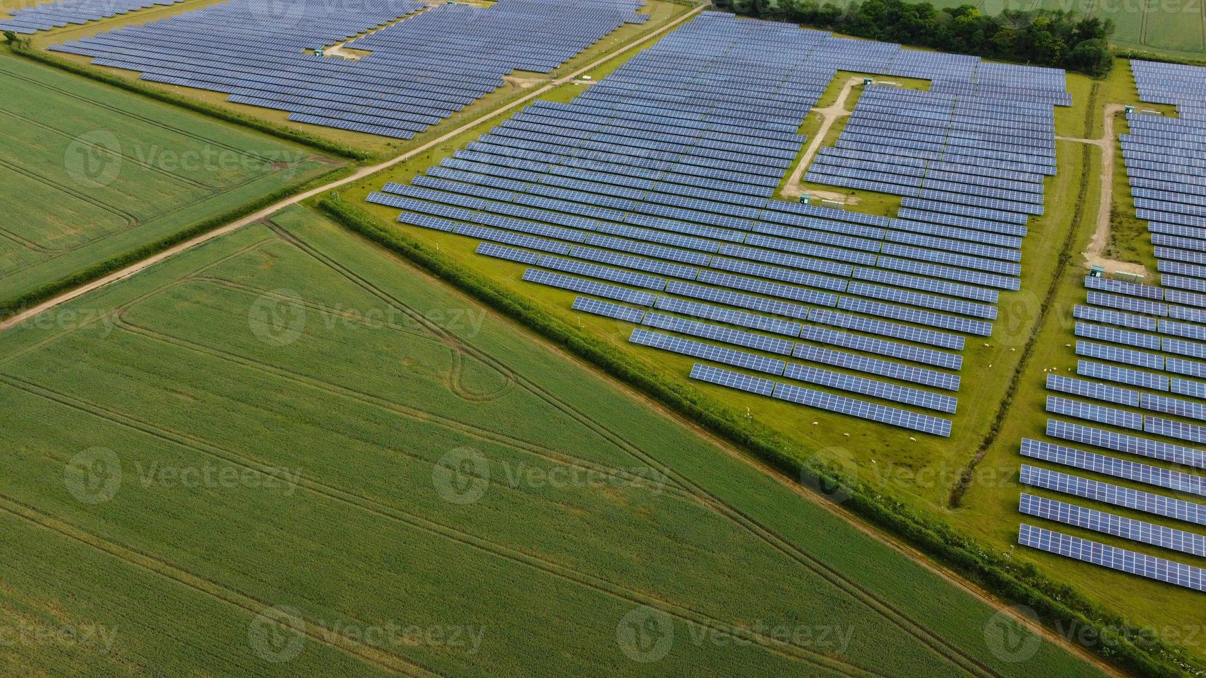 Aerial footage High Angle view of Green Energy natural Generators Sources of Wind turbines and solar panels Farms at England UK photo