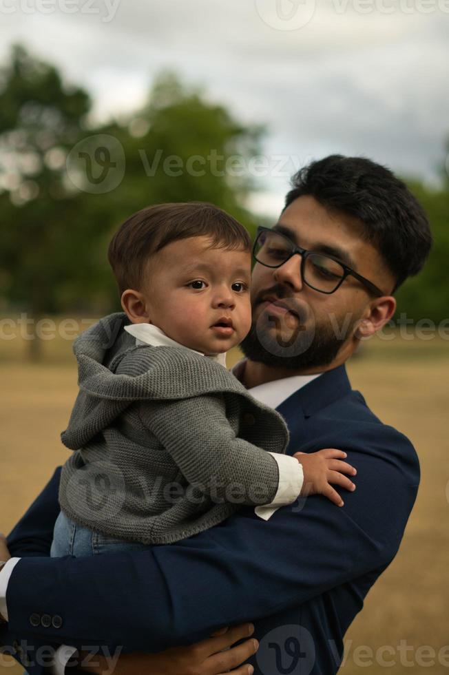 Asian Pakistani Father is holding his 11 Months Old Infant at Local Park photo