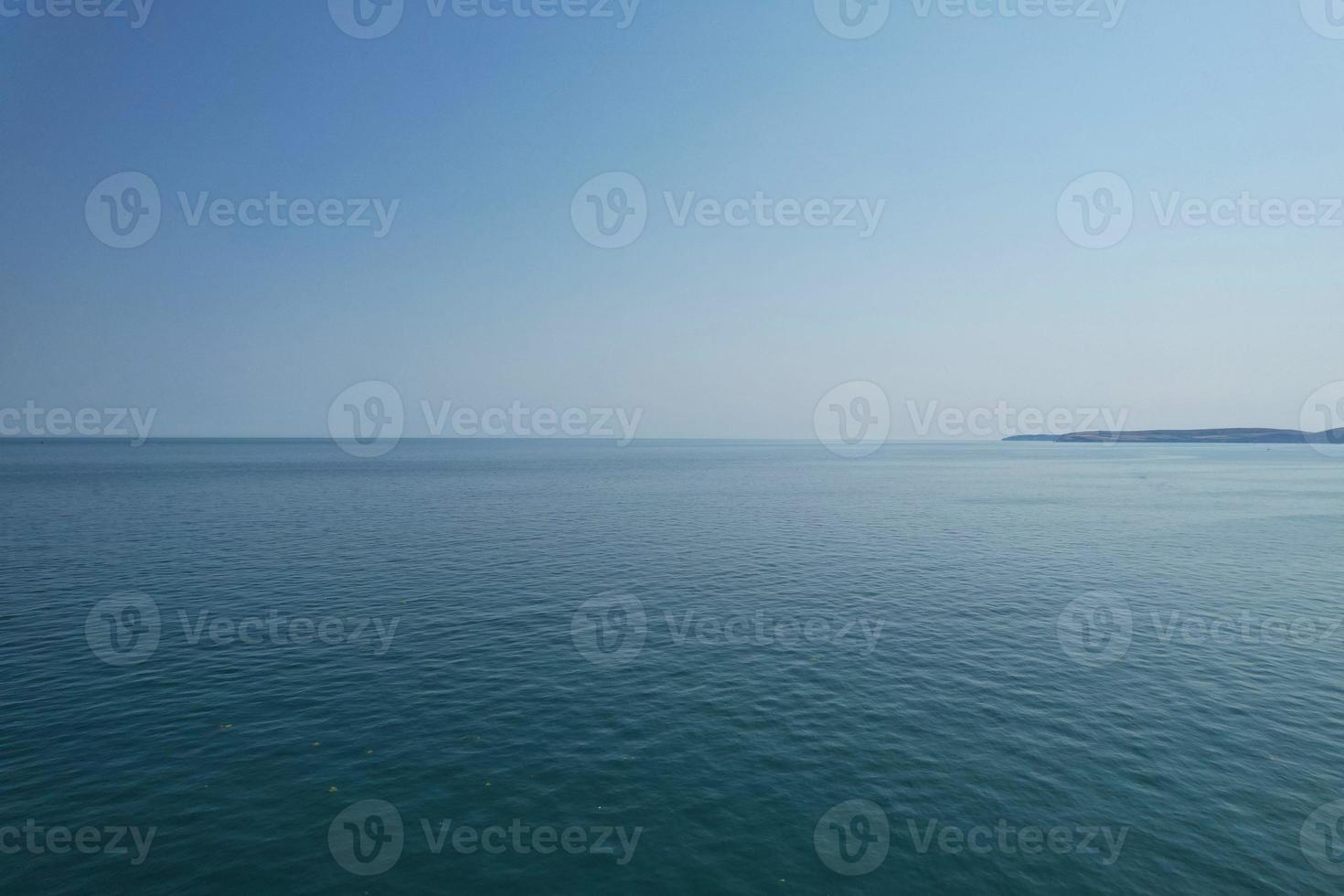 High Angle Footage and Aerial view of Ocean with High Speed Boats, People are having fun and enjoying hottest weather at Bournemouth Beach Sea Front of England UK. photo