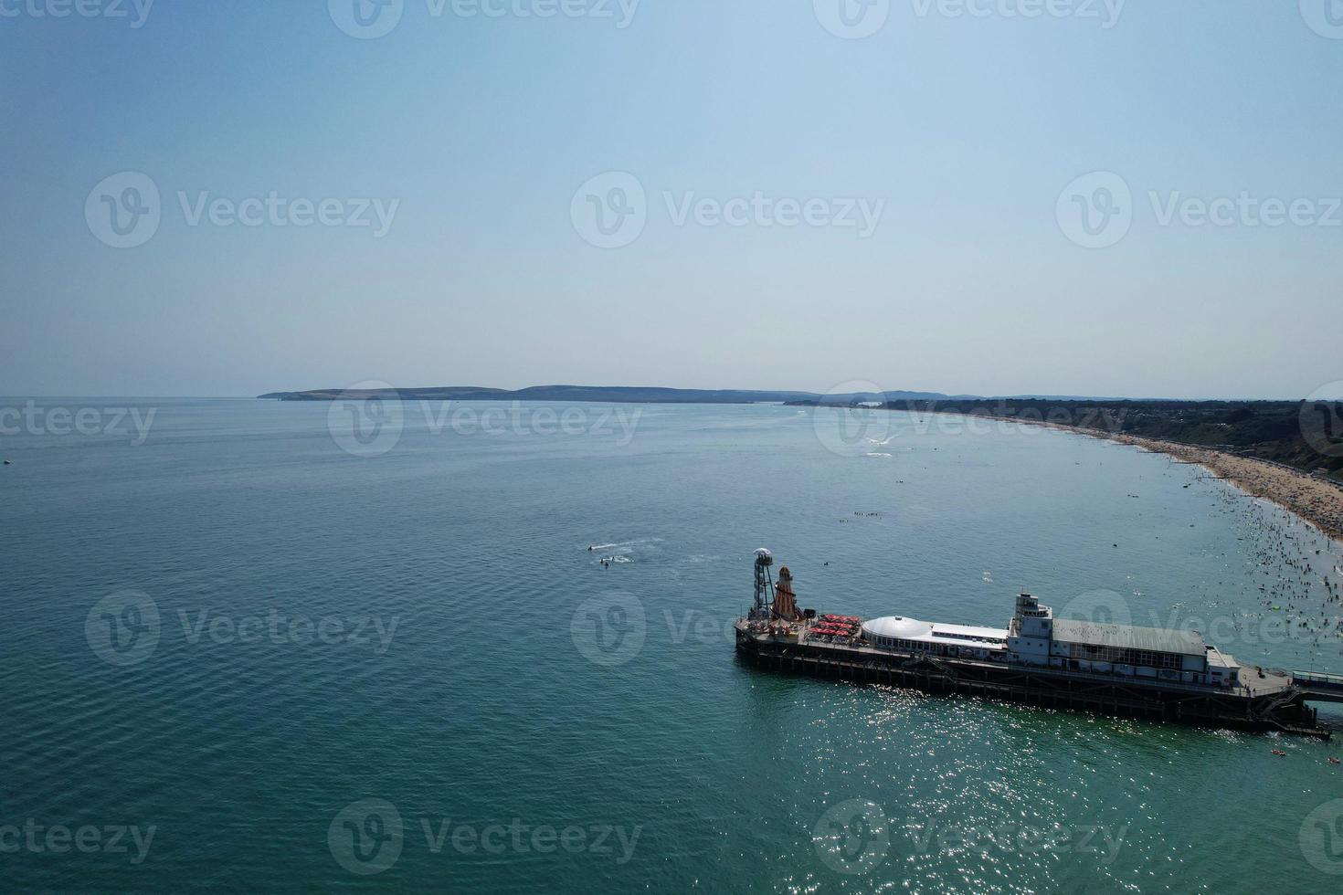High Angle Footage and Aerial view of Ocean with High Speed Boats, People are having fun and enjoying hottest weather at Bournemouth Beach Sea Front of England UK. photo