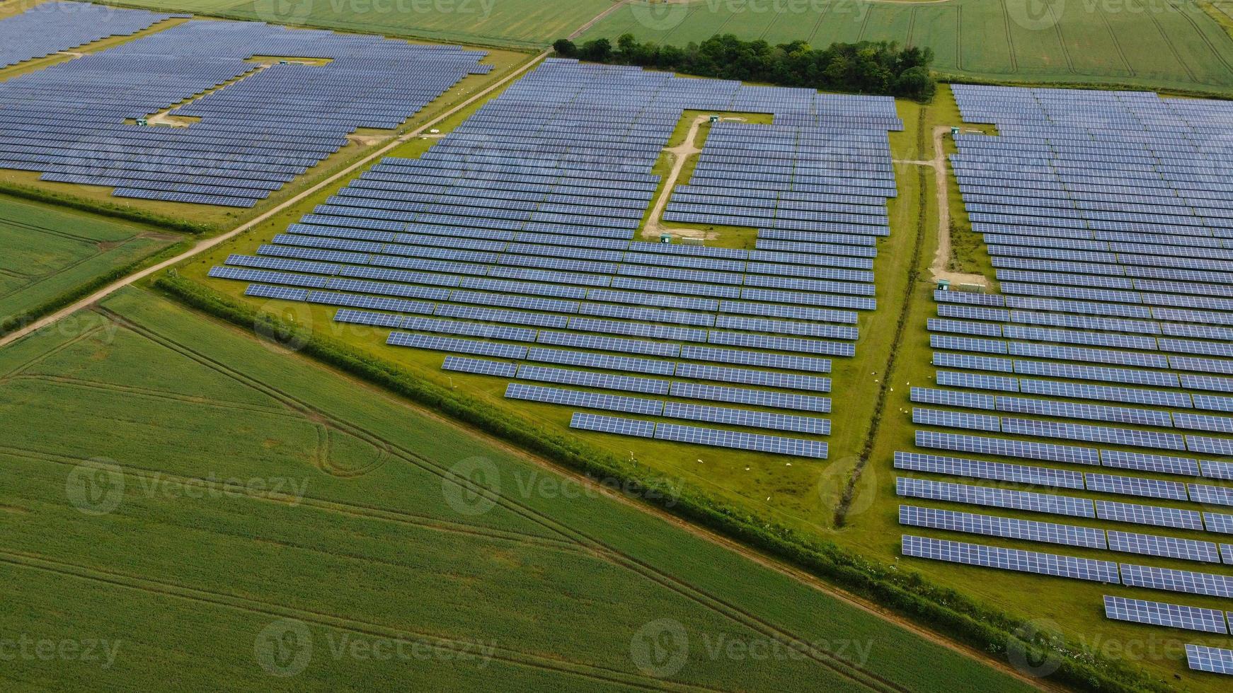 Aerial footage High Angle view of Green Energy natural Generators Sources of Wind turbines and solar panels Farms at England UK photo