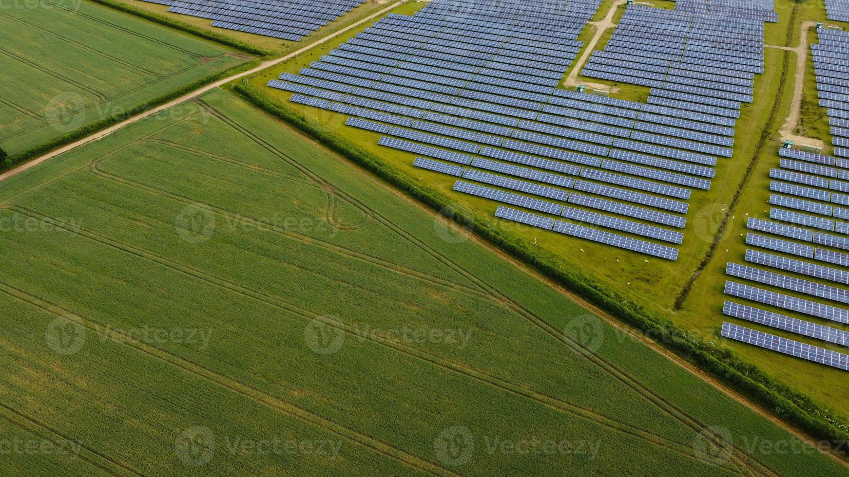 Aerial footage High Angle view of Green Energy natural Generators Sources of Wind turbines and solar panels Farms at England UK photo