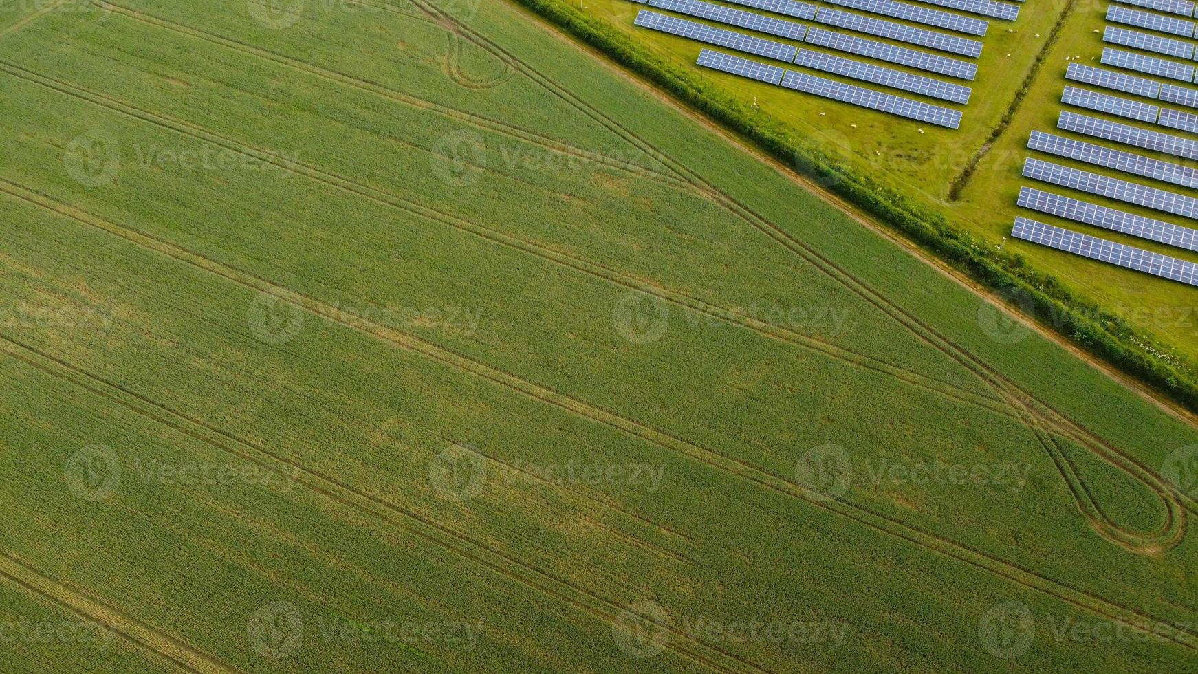 Aerial footage High Angle view of Green Energy natural Generators Sources of Wind turbines and solar panels Farms at England UK photo