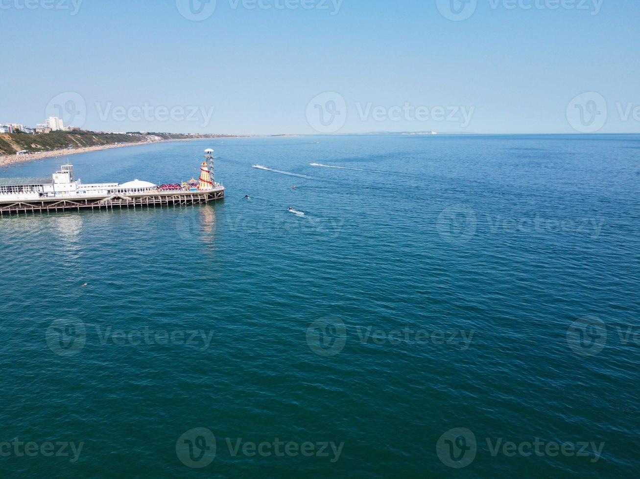 High Angle Footage and Aerial view of Ocean with High Speed Boats, People are having fun and enjoying hottest weather at Bournemouth Beach Sea Front of England UK. photo