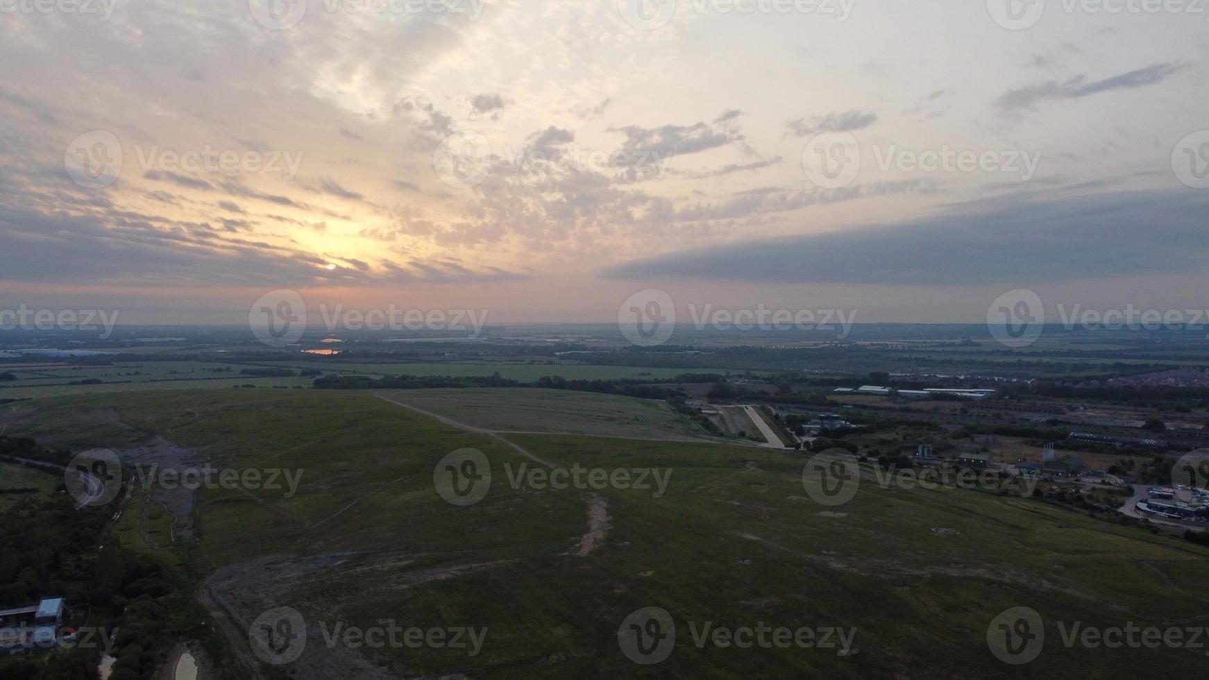 High Angle Aerial View footage over Windmill Wind Turbine at Stewartby Lake of England at Sunrise photo