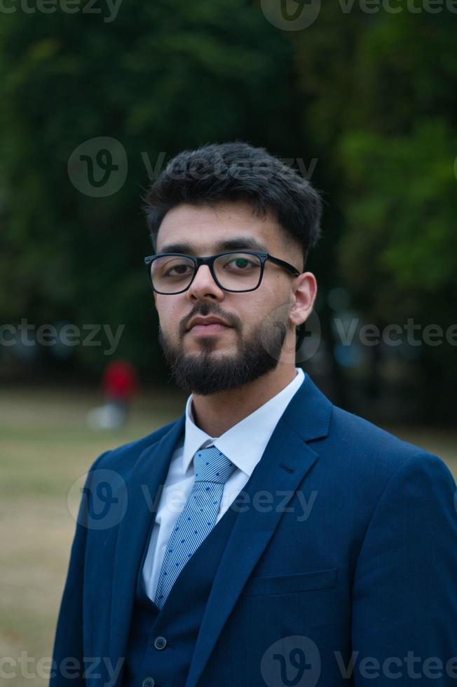 Young Businessman is posing at local park of Luton England UK photo