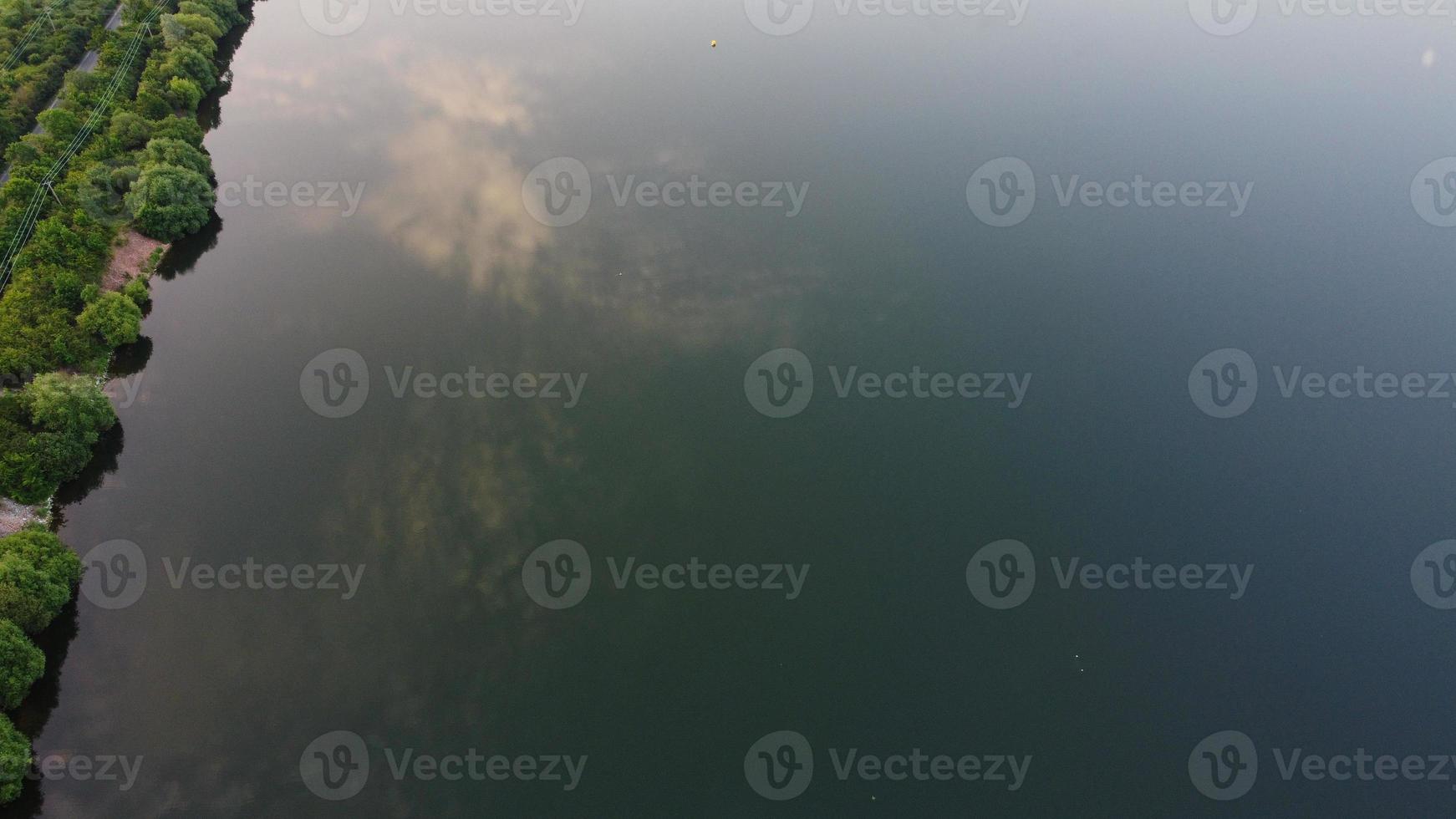 High Angle Aerial View footage over Windmill Wind Turbine at Stewartby Lake of England at Sunrise photo
