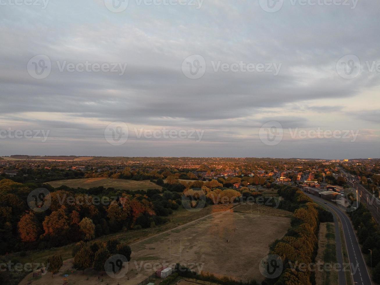 Beautiful Sunset over British Town, Colourful Sky with yellow, orange and black clouds over light blue sky photo