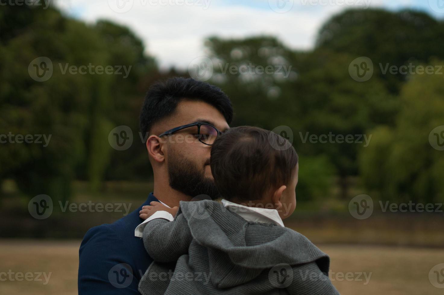 Asian Pakistani Father is holding his 11 Months Old Infant at Local Park photo