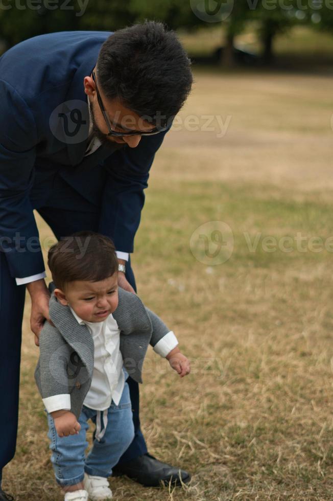 Asian Pakistani Father is holding his 11 Months Old Infant at Local Park photo