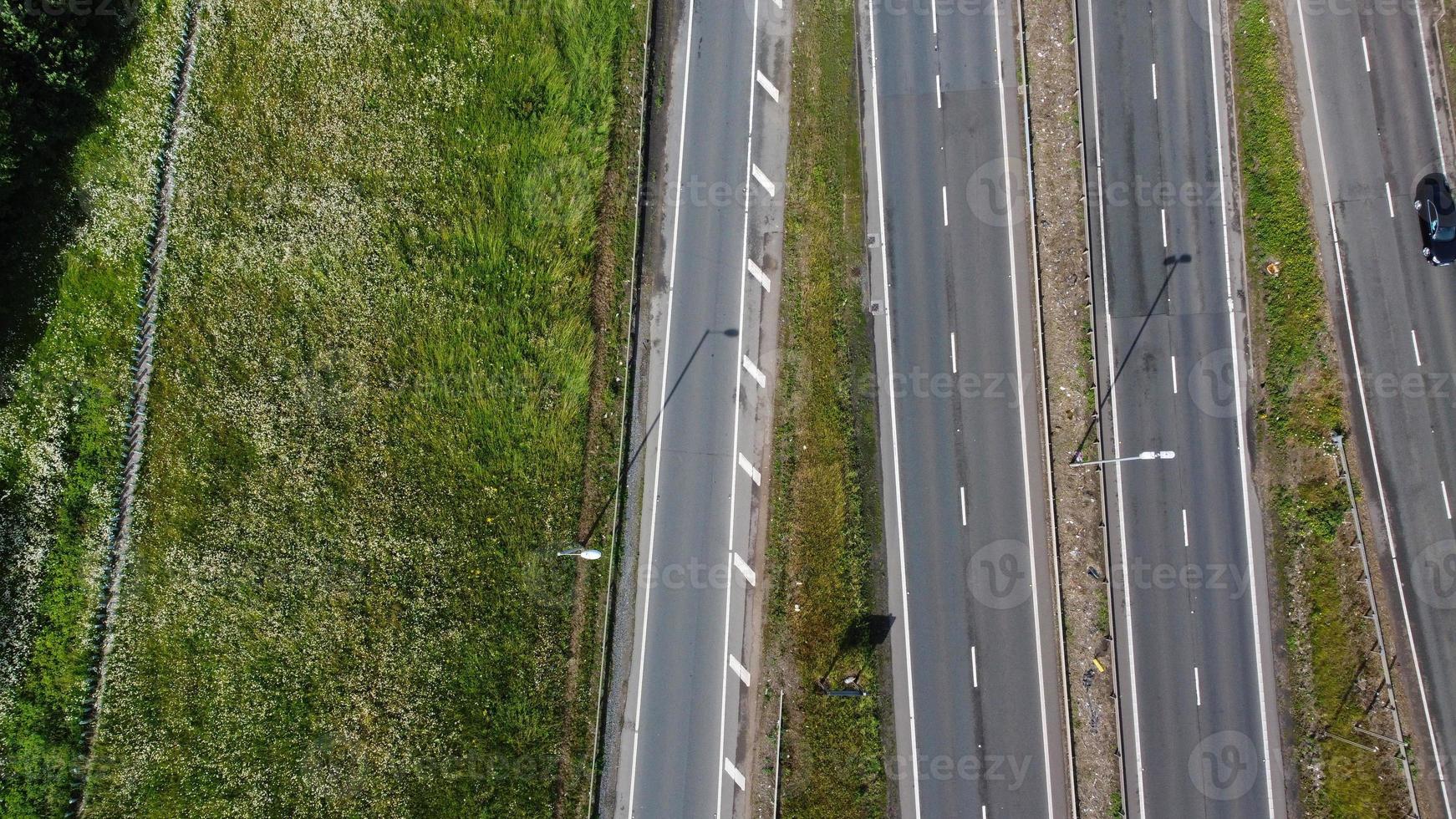 High Angle aerial view of British Roads and Traffic Passing through countryside of England UK photo
