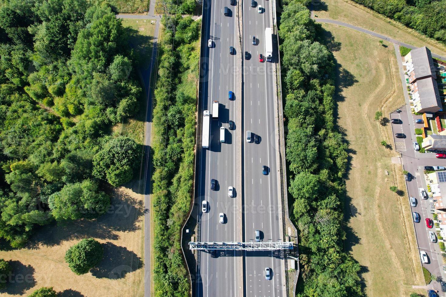 High Angle aerial view of British Roads and Traffic Passing through countryside of England UK photo