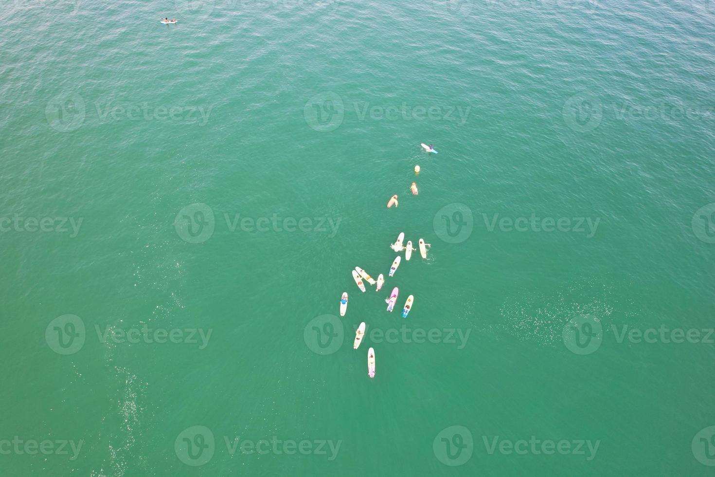 High Angle Footage and Aerial view of Ocean with High Speed Boats, People are having fun and enjoying hottest weather at Bournemouth Beach Sea Front of England UK. photo