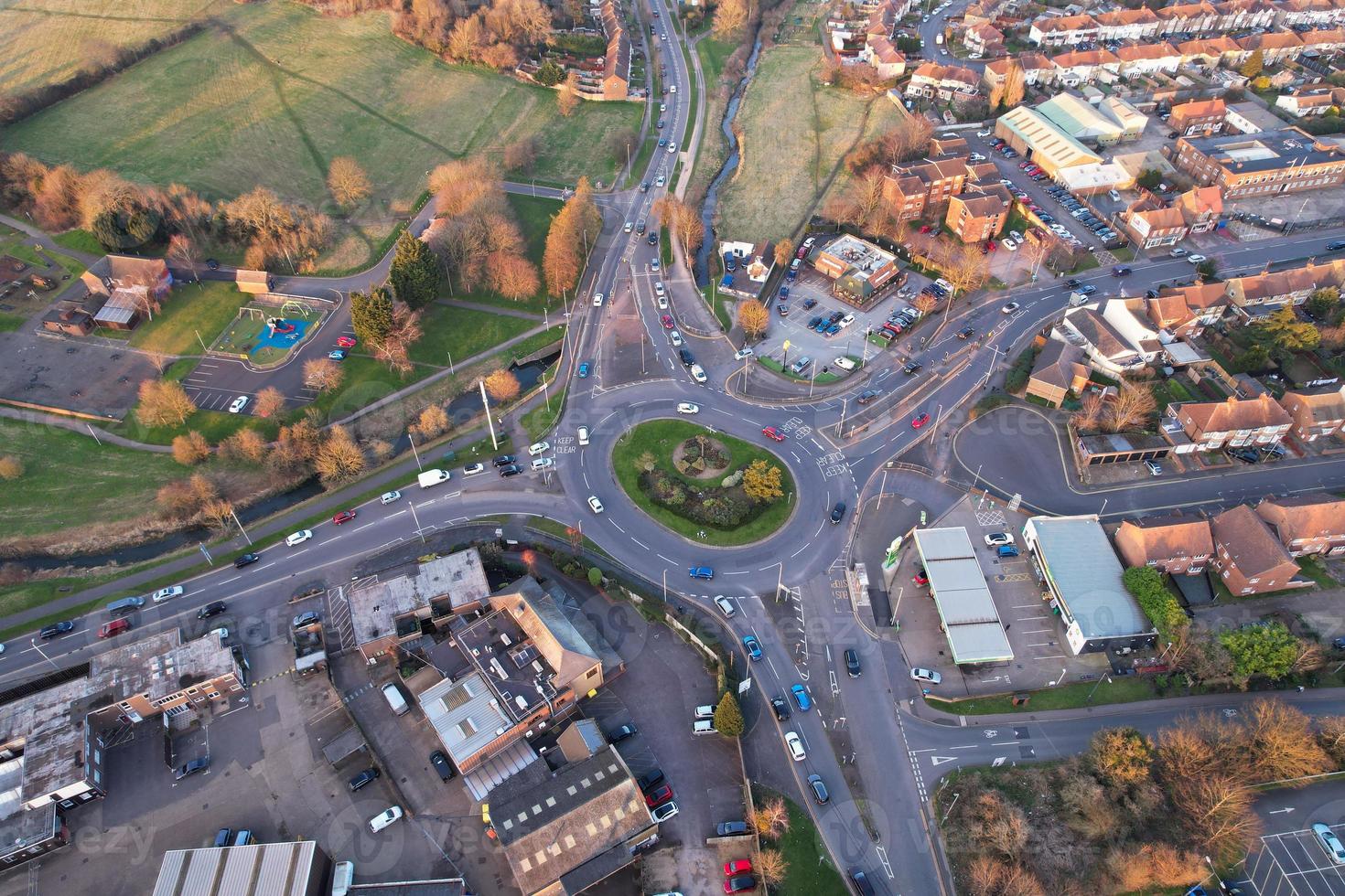 High Angle aerial view of British Roads and Traffic Passing through City and countryside of England UK photo