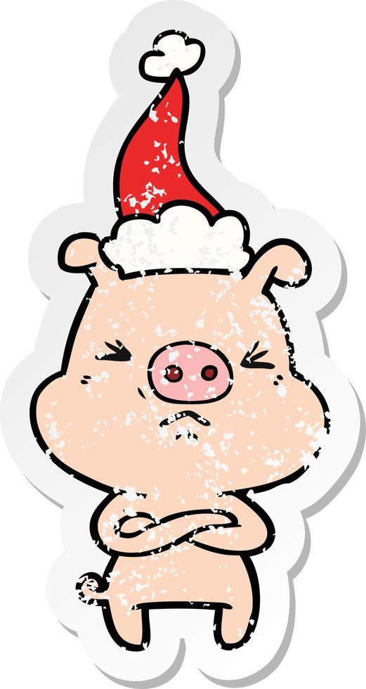 distressed sticker cartoon of a angry pig wearing santa hat vector