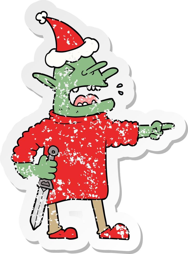 distressed sticker cartoon of a goblin with knife wearing santa hat vector