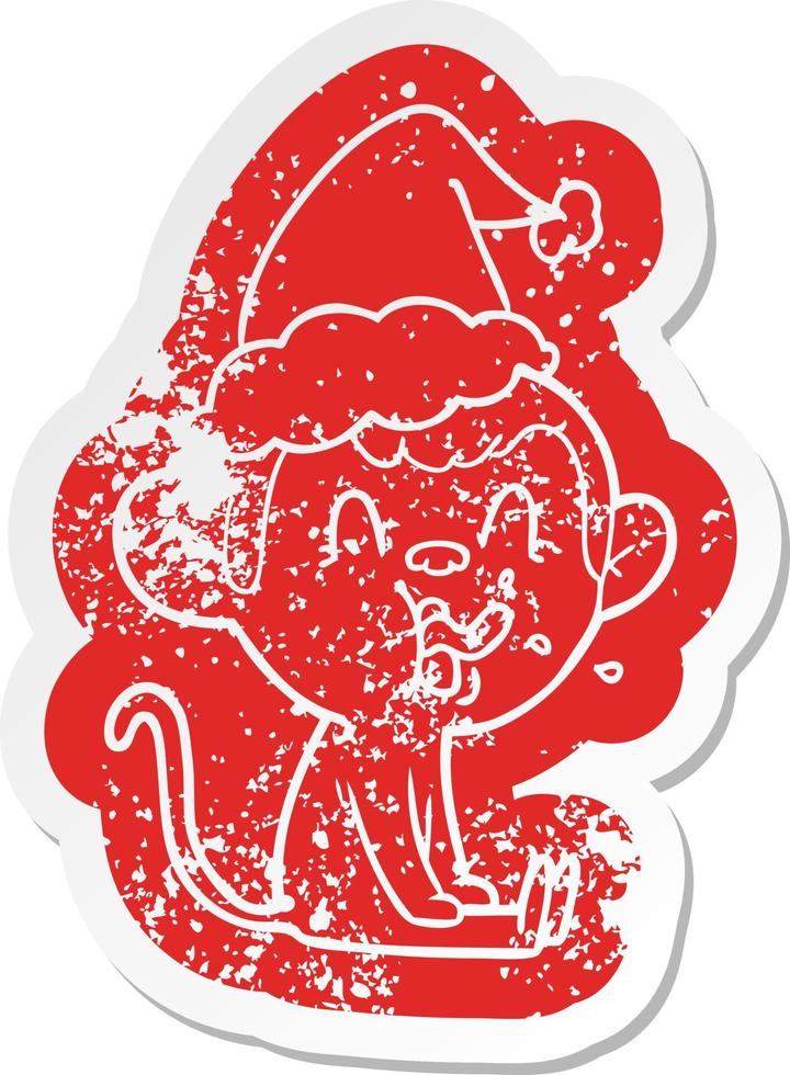 crazy cartoon distressed sticker of a monkey sitting wearing santa hat vector