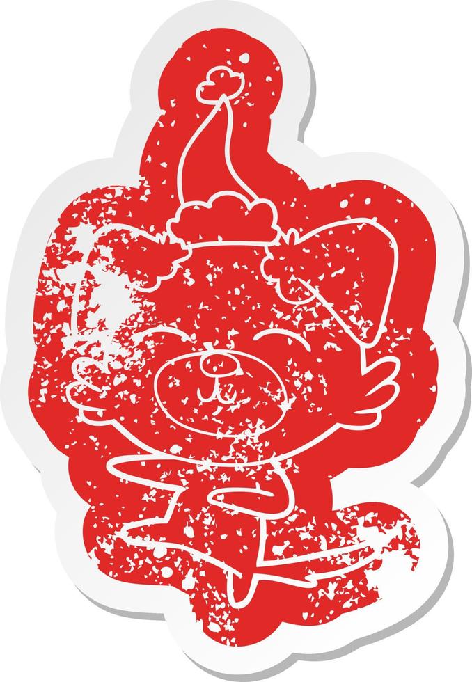 cartoon distressed sticker of a dog kicking wearing santa hat vector