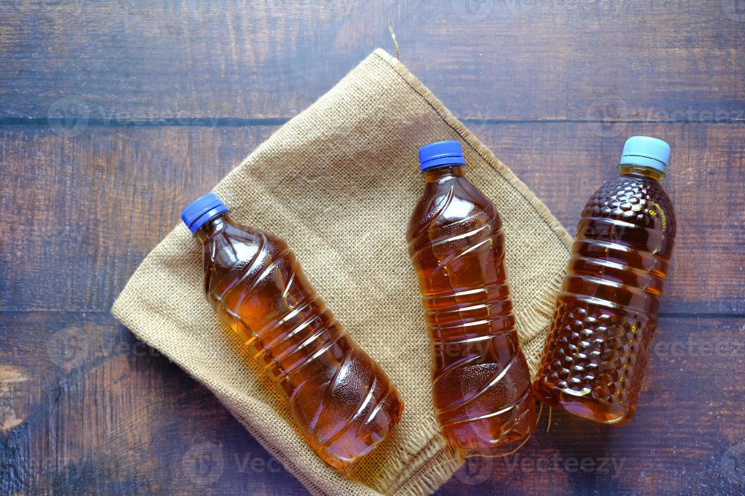 Mustard oil in a plastic jar on table photo