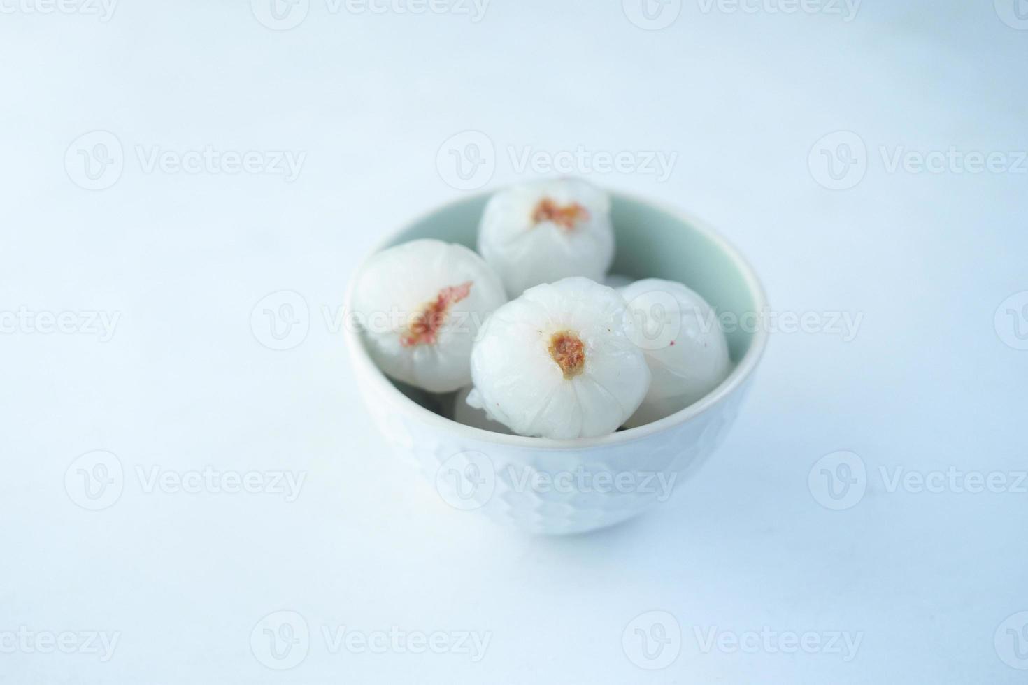 fresh Lychee in a bowl on white background photo