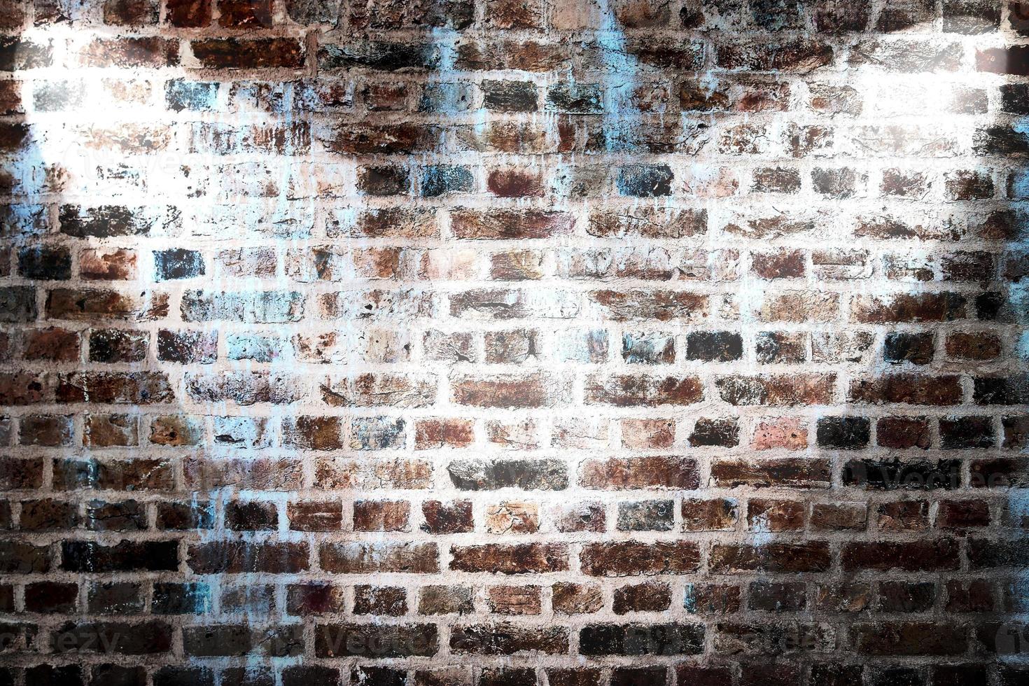 Aged and weathered brick wall textures with very bright spotlight illumination photo