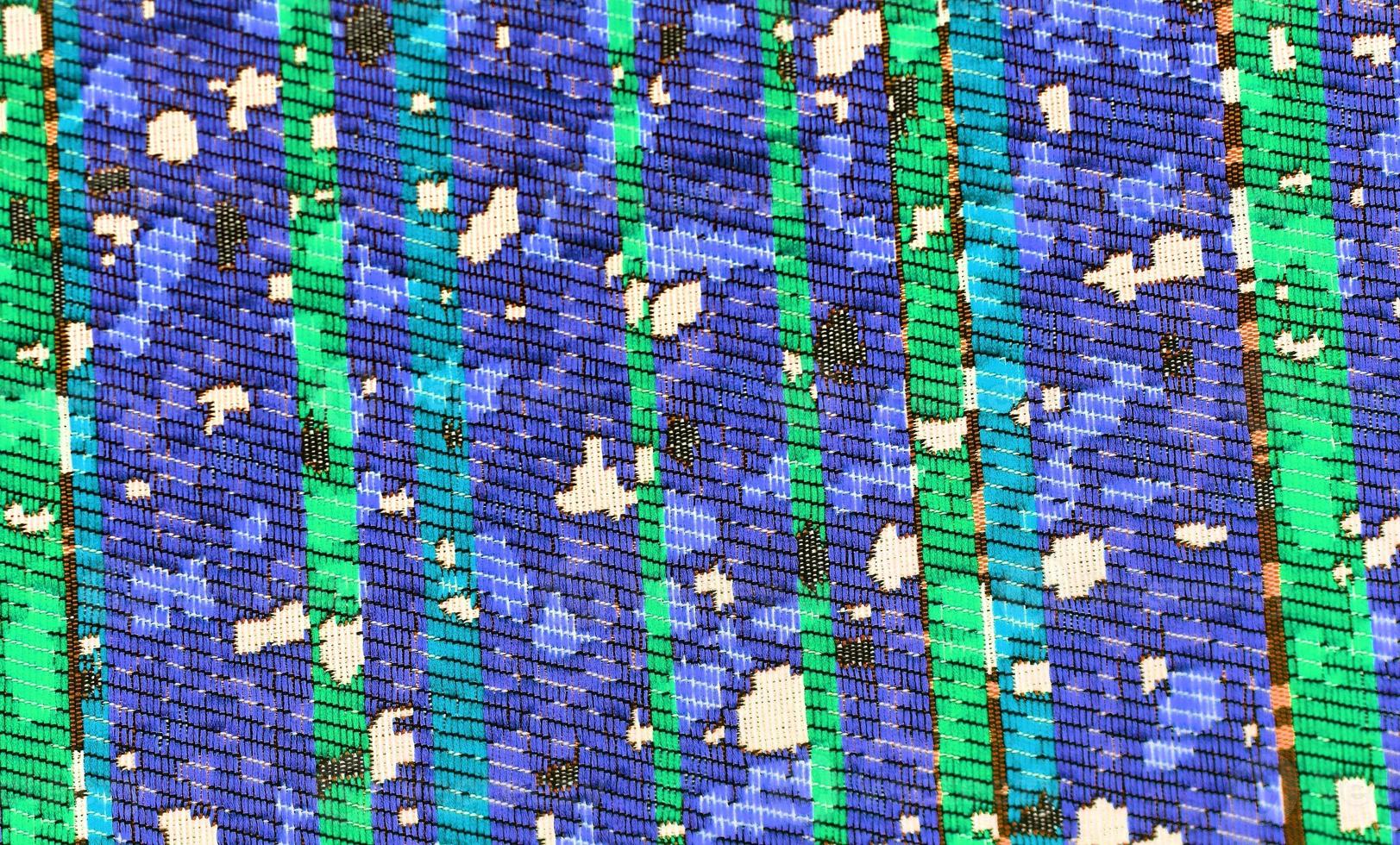 Detailed close up view on samples of cloth and fabrics in different colors found at a fabrics market photo