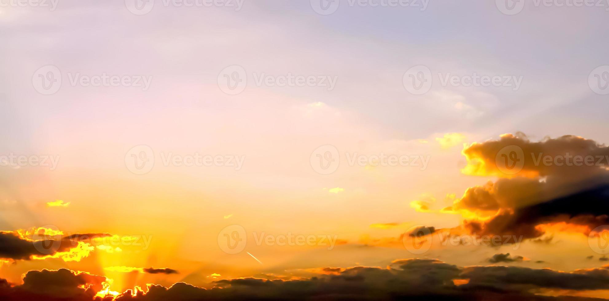 Beautiful high resolution panorama of orange and red sunset clouds in the evening sky photo