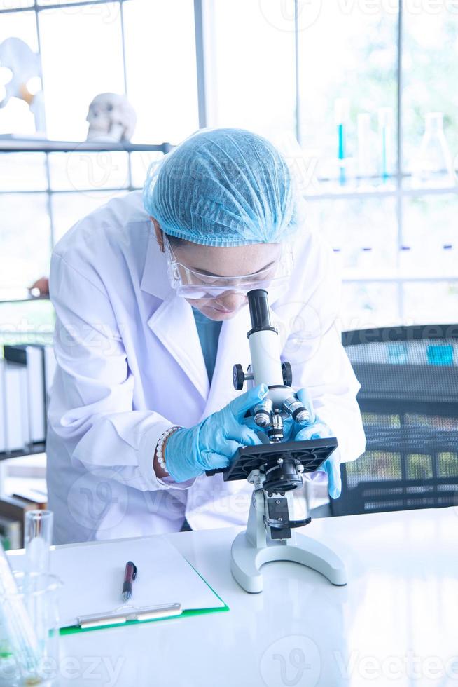 Asian woman scientist, researcher, technician, or student conducted research in laboratory photo