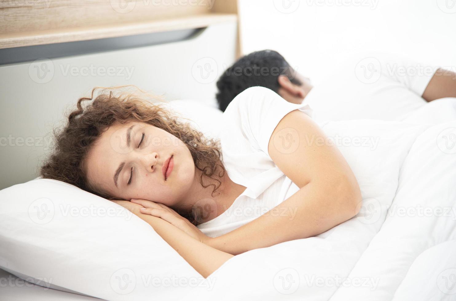 Lover concept. Young attractive couple lying under white blanket in bed photo