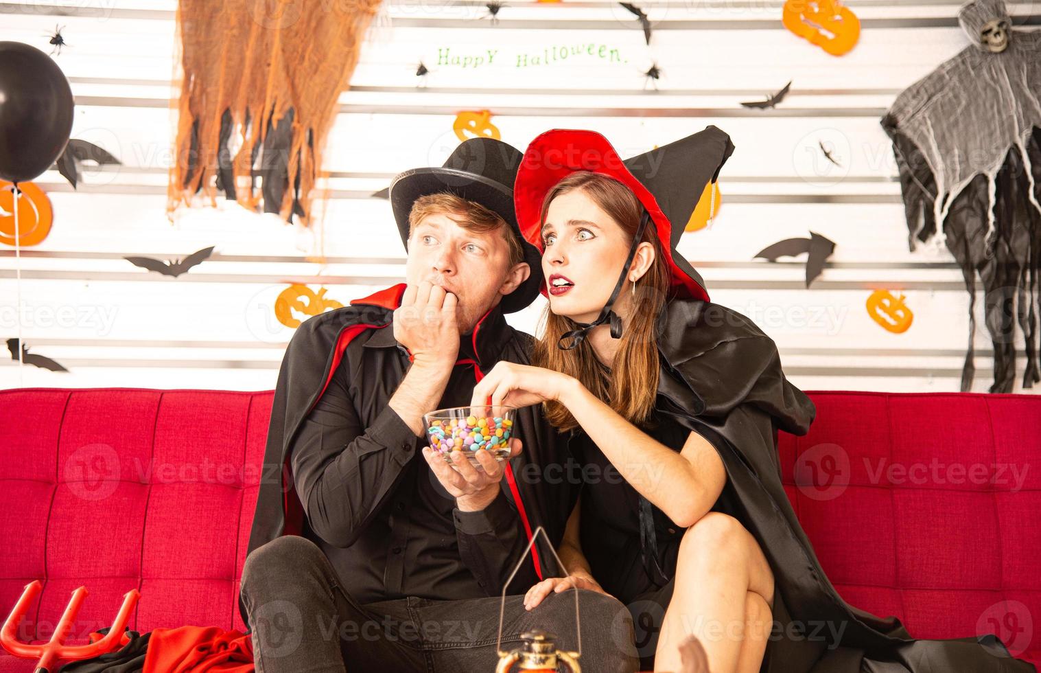 Happy Halloween party concept. Young man and woman wearing as vampires, witch or ghost celebrate the halloween festival photo