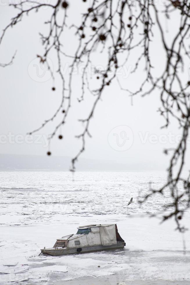 Boat on a frozen river photo