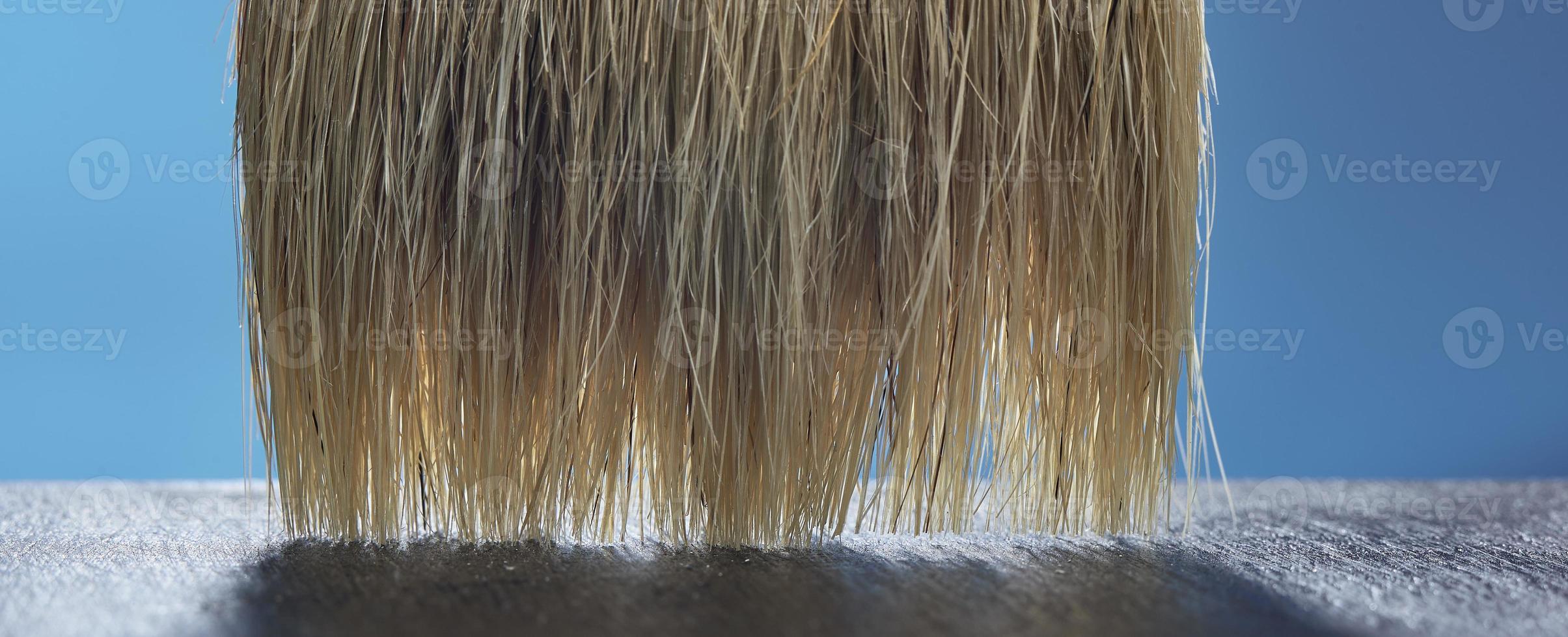 Paint brush, bristles close-up on a blue background. photo