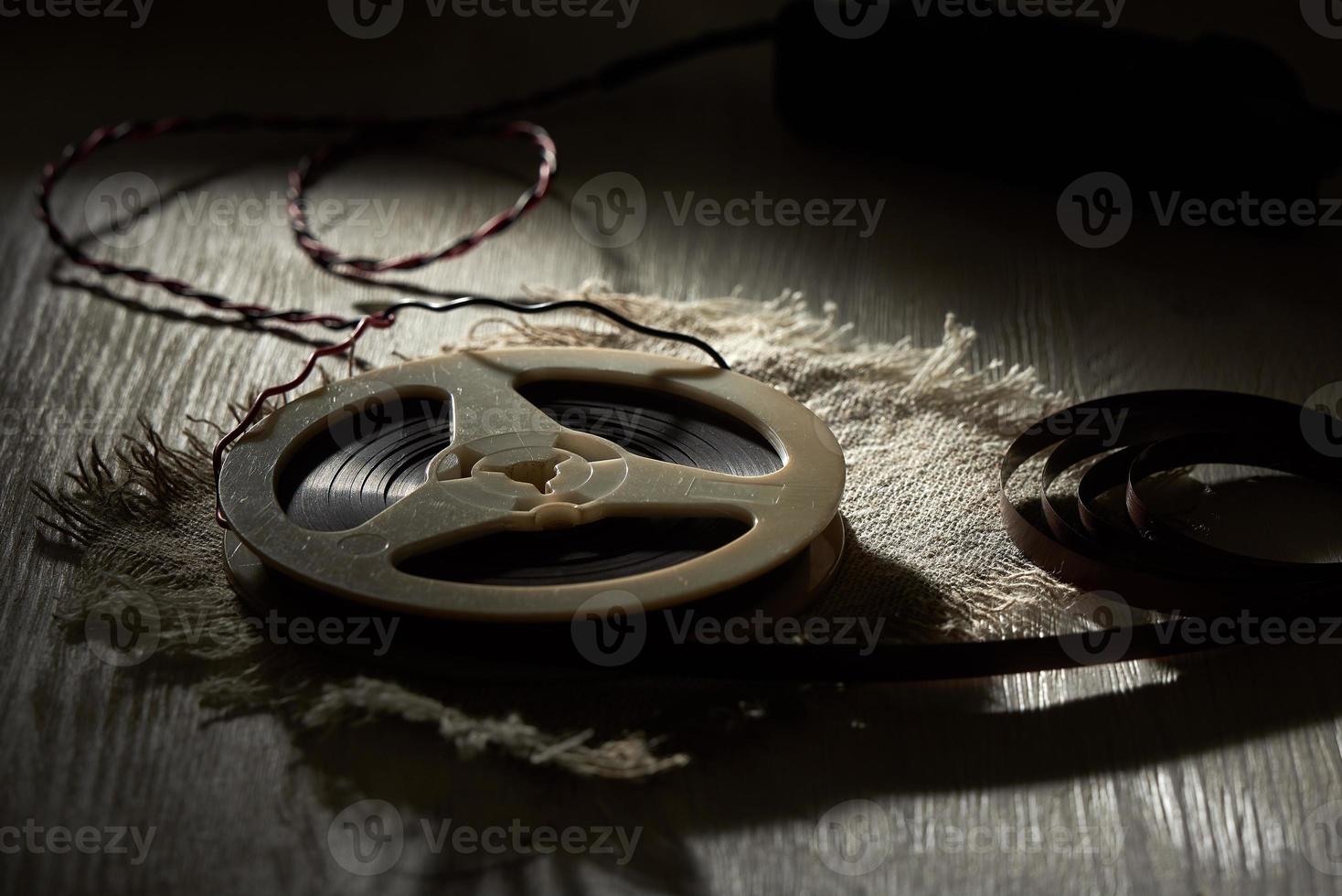 Audio magnetic recording tape spools on white wooden table in the shadow. The concept of retro music. photo