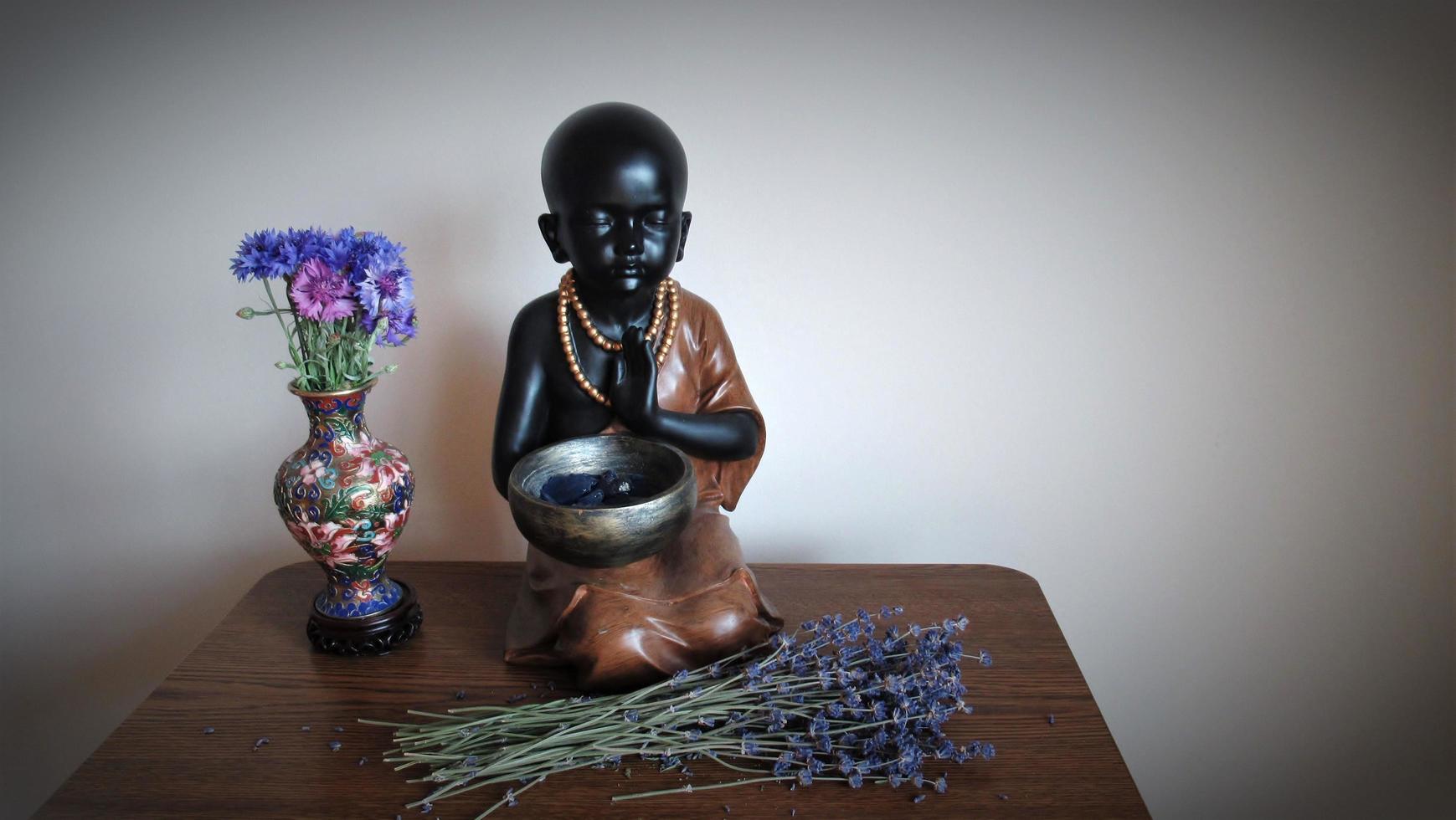 baby monk, buddha, rose flower vase, home meditation photo