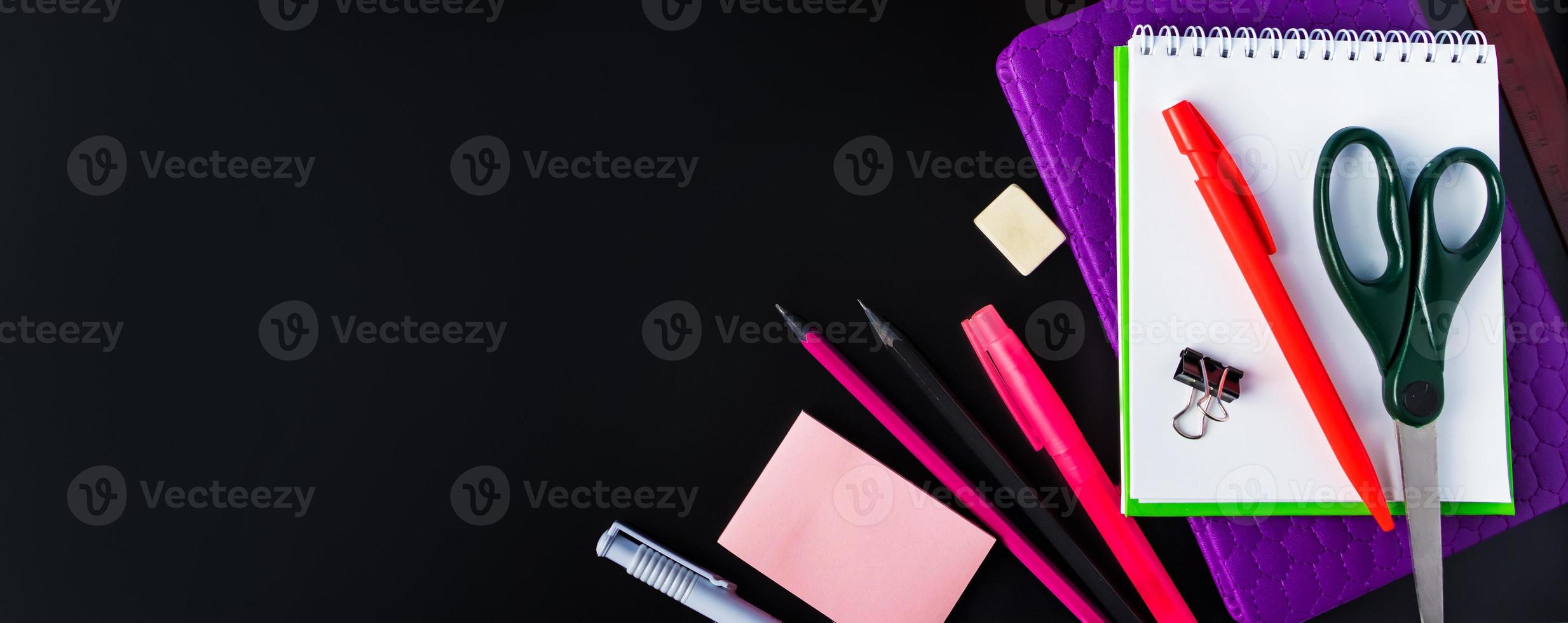 Back to school concept. Office supplies on chalkboard background. Banner format photo