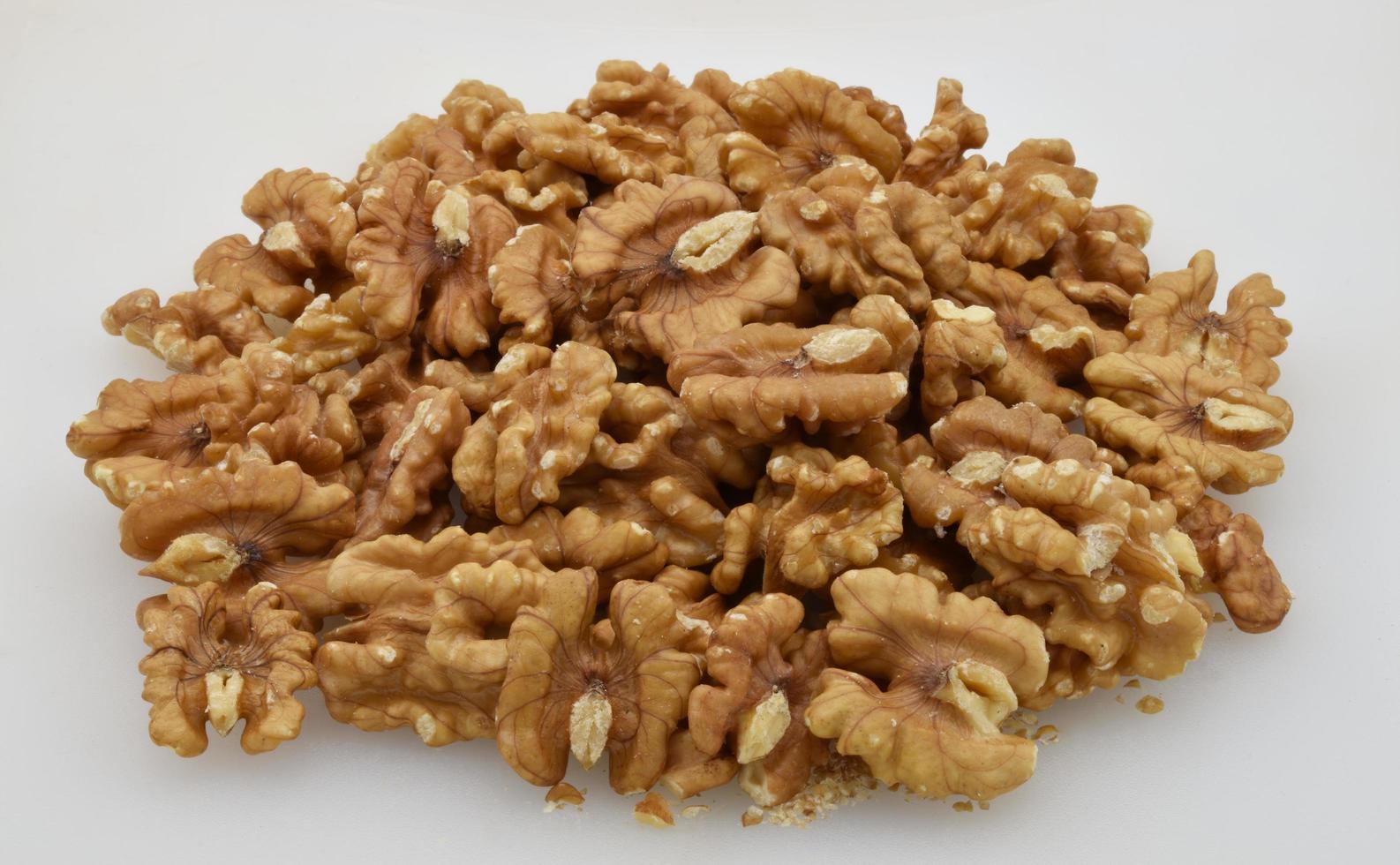 Pile of walnuts isolated on white background. photo
